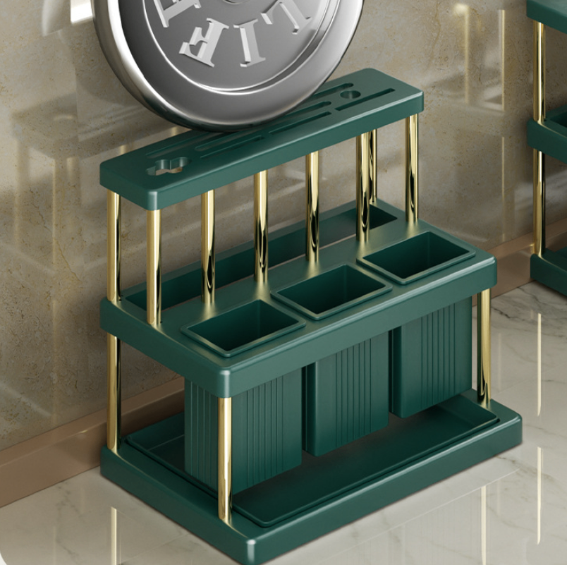 Green kitchen organizer shown holding a lid and utensils