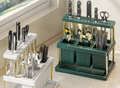 White and green countertop kitchen utensil organizers shown with knives and cutlery